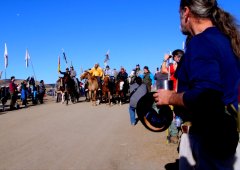 Indigenous activists on horseback in front of blue sky