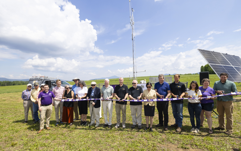 UAlbany and Uihlein Foundation community members cut a purple ribbon to celebrate the opening of the Mesonet's Lake Placid site. 