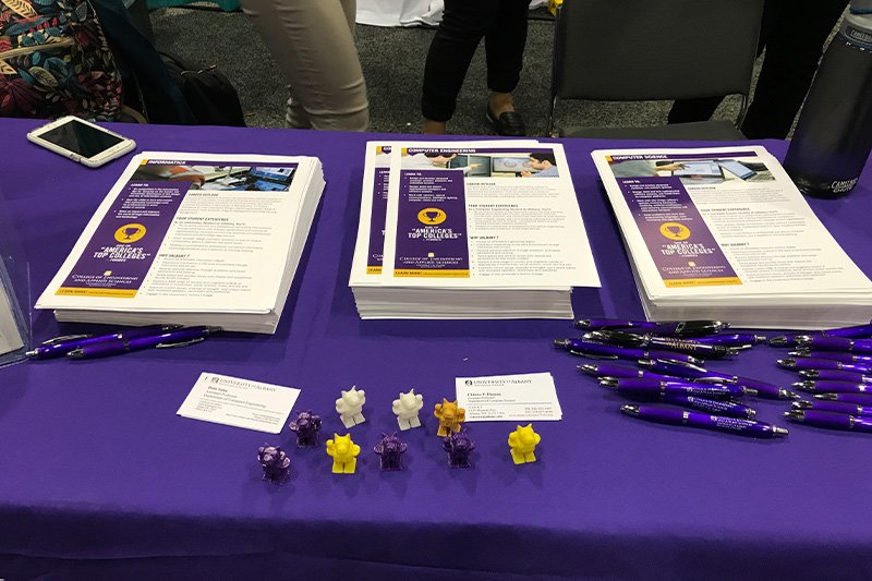 handouts at a purple table