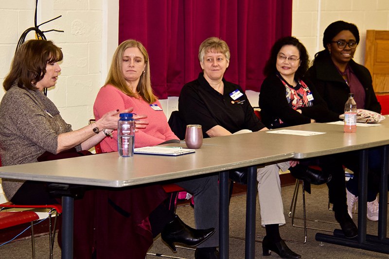 a group of 5 people with one answering a question