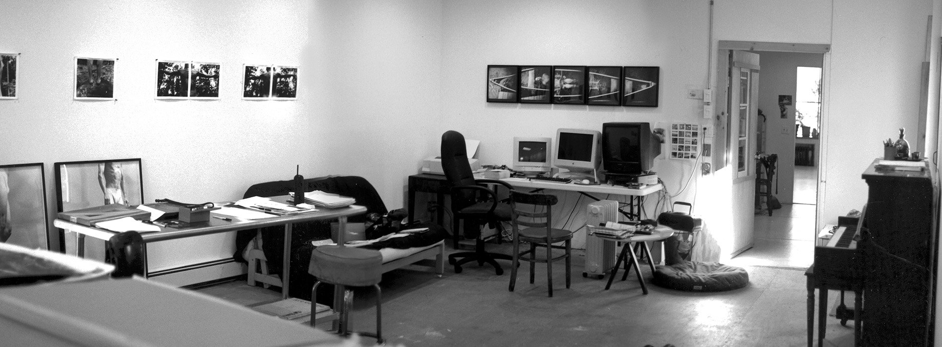 Black and white photograph of a cluttered workspace