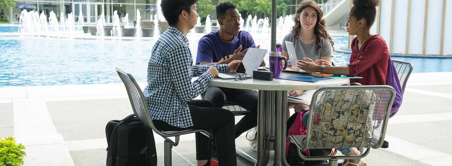 Four students sitting at a table together