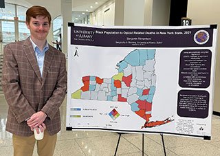 Benjamin Richardson presents his opioid research poster at UAlbany's Showcase day.