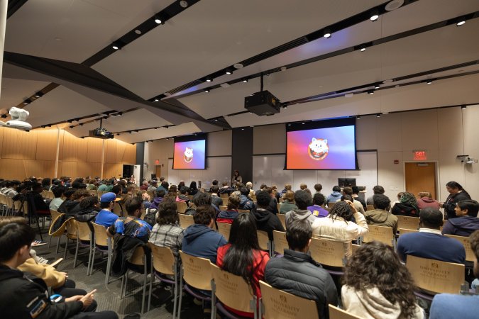 A large group of students sit for a presentation during Wolfjam. 