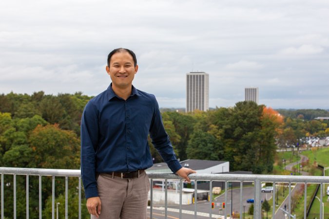 Brian Tang stands outside the weather observation deck at ETEC on UAlbany