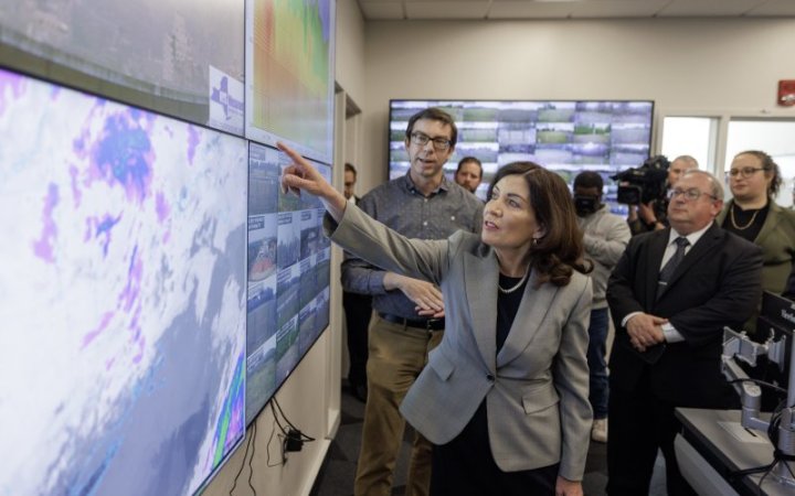 Gov. Kathy Hochul points at a screen inside the New York State Mesonet operations center at ETEC.