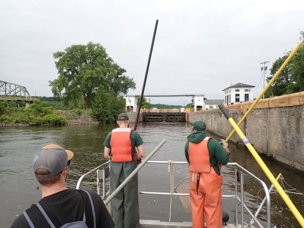 A group including Evan Walters fishing off a boat on the Mohawk River.