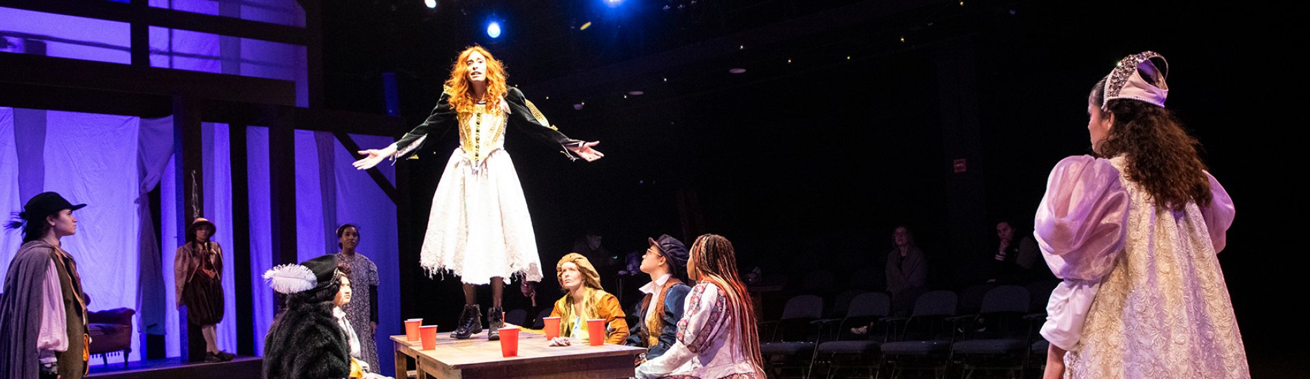 Students performing in Taming of the Shrew on stage in the UAlbany Performing Arts Center.