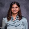 College student smiling in headshot wearing a teal blouse