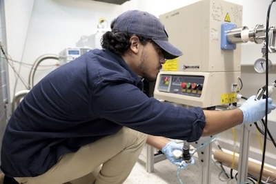 Student adjusts testing equipment.