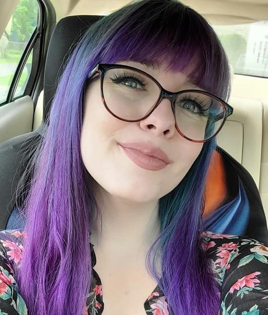 A photo of Megan. She has purple hair.